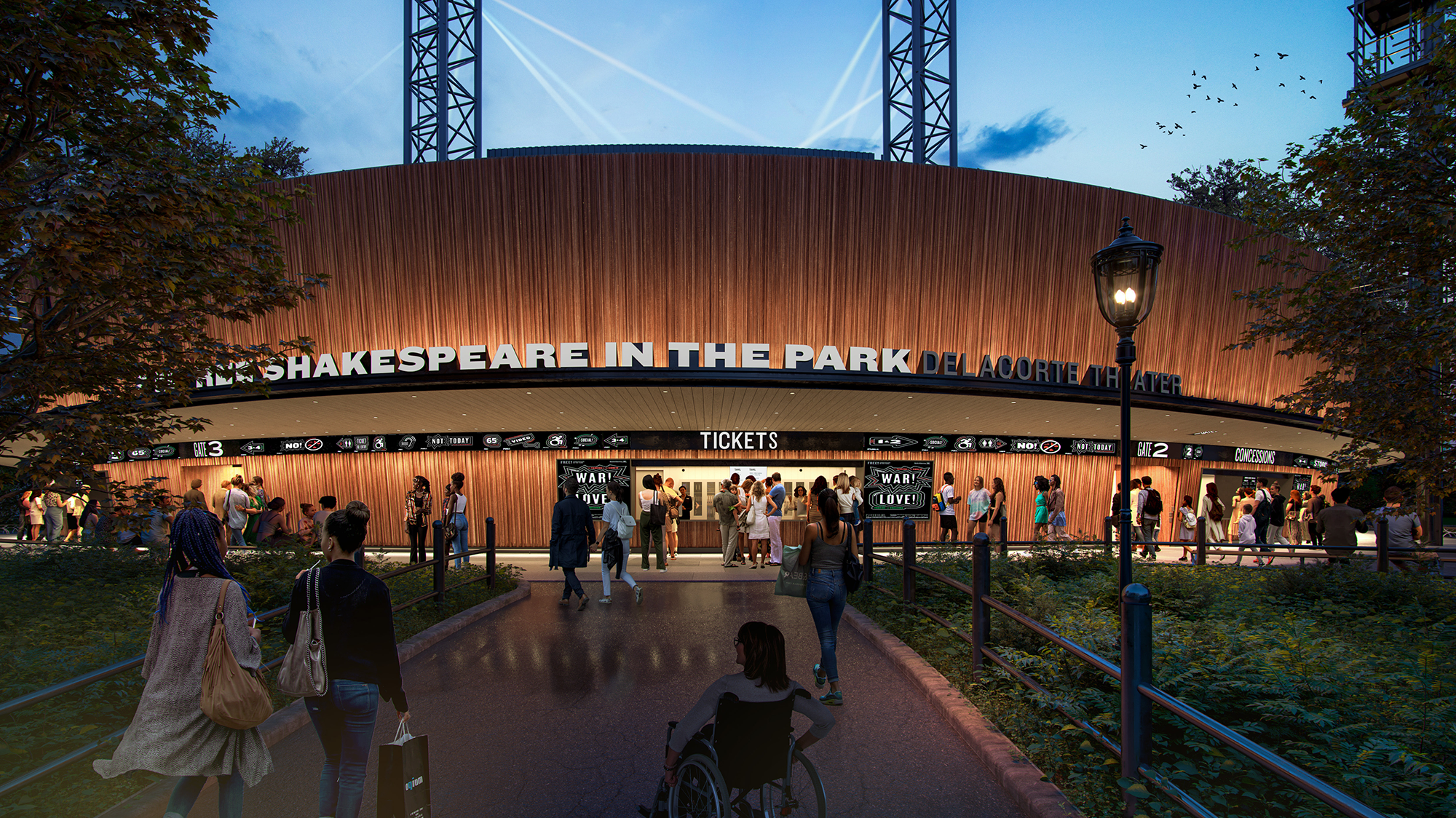 A crowd approaches the ticket area of the Delacorte Theater at dusk, with illuminated signage for Shakespeare in the Park and people entering, including a person using a wheelchair in the foreground.